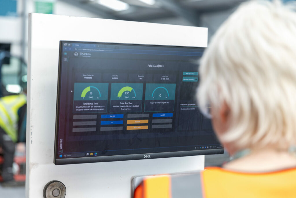 Thurston team member looking at digital manufacturing screen